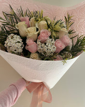Load image into Gallery viewer, Bouquet of pastel roses with foliage and textural ingredients , gift wrapped in pastel /white paper with ribbon bow