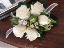 Load image into Gallery viewer, A wrist corsage featuring white roses, green leaves, and decorative elements for school ball .
