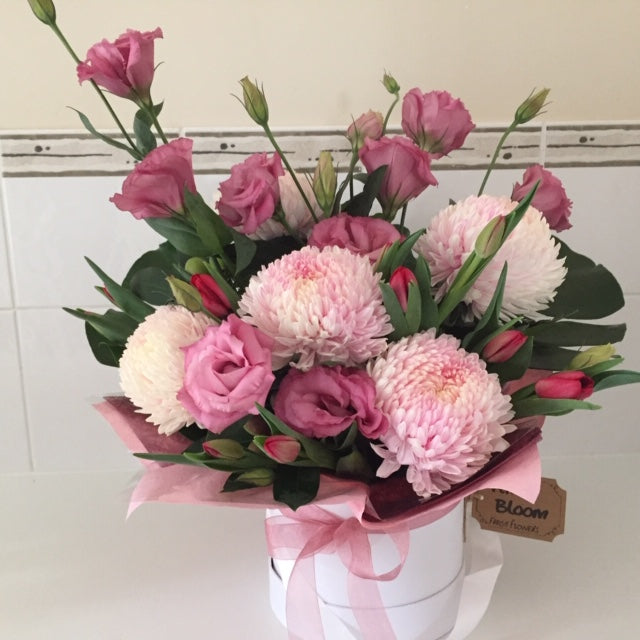 Pretty box arrangement of fresh in season blooms , pinks , pastels 