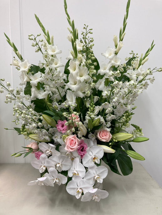 Large ,Tall flower arrangement suitable for a eye catching area like church funeral flowers,Wedding ceremony flowers,Event styling flowers. Choice of white,pastel flowers example gladioli,delphinium,oriental lillium,roses,lisianthus,roses,phalaenopsis orchids.