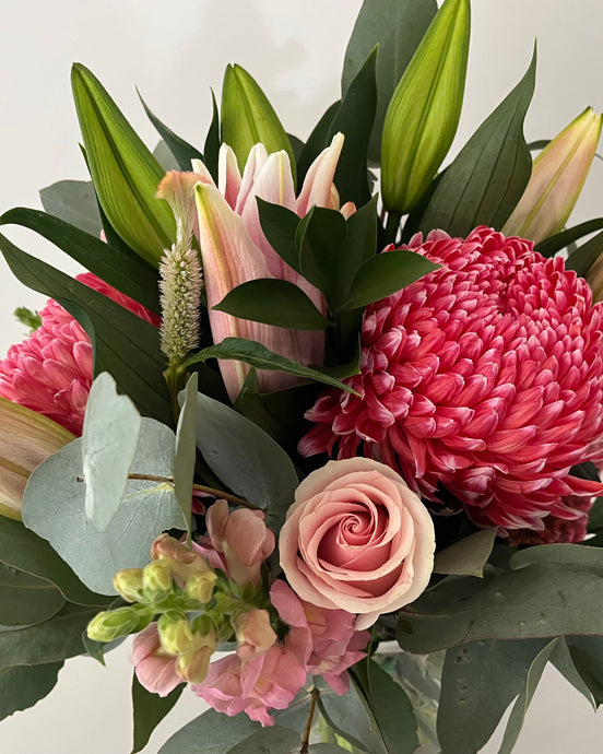 Beautiful lush bouquet, may include oriental lillium,disbuds,roses snapdragons,in seson foliage arranged in to a hand tied bouquet and placed in to a vase.delivered with a bow and card.